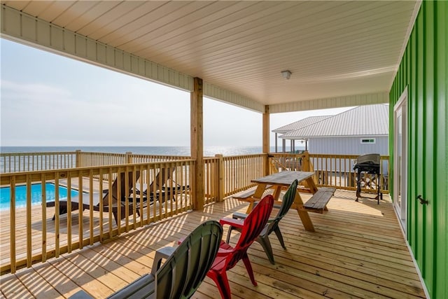 wooden terrace with a water view and a beach view