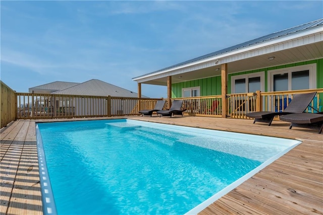 view of pool featuring a fenced in pool and a deck