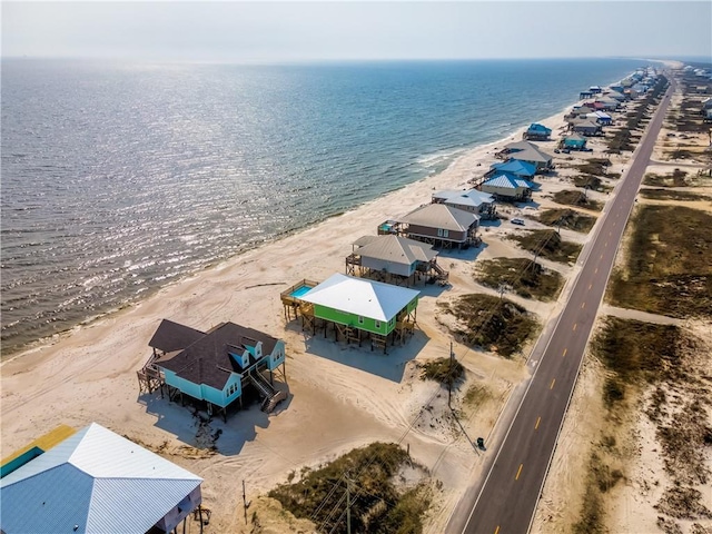 birds eye view of property with a water view and a view of the beach