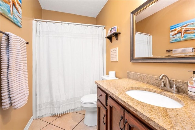 bathroom featuring tile patterned flooring, vanity, and toilet