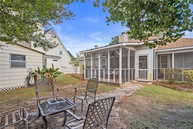 exterior space with a fire pit and a sunroom