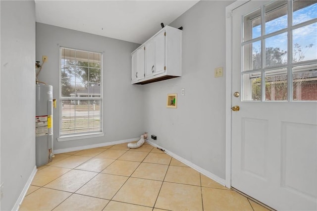 laundry room with cabinets, hookup for a washing machine, electric water heater, and light tile patterned floors