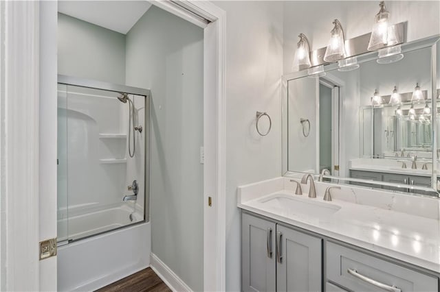 bathroom with vanity, hardwood / wood-style flooring, and shower / bath combination with glass door