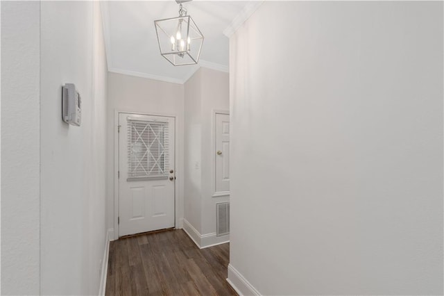 corridor featuring a notable chandelier, dark hardwood / wood-style floors, and crown molding