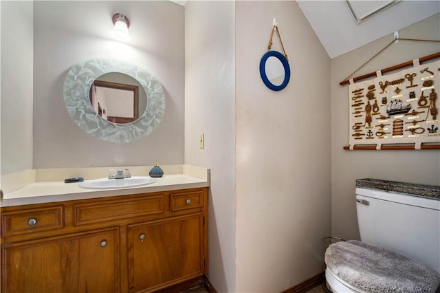 9731 Hamilton Creek Dr S, Mobile, AL 36695 - bathroom featuring toilet, vanity, and vaulted ceiling