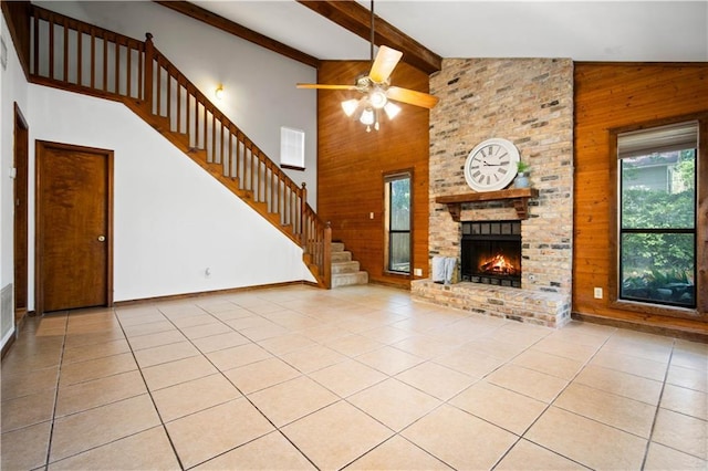 9731 Hamilton Creek Dr S, Mobile, AL 36695 - unfurnished living room with wooden walls, high vaulted ceiling, light tile patterned floors, stairs, and beam ceiling