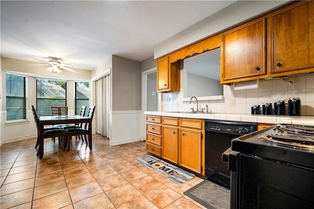 9731 Hamilton Creek Dr S, Mobile, AL 36695 - kitchen with a sink, black appliances, tile countertops, brown cabinetry, and ceiling fan
