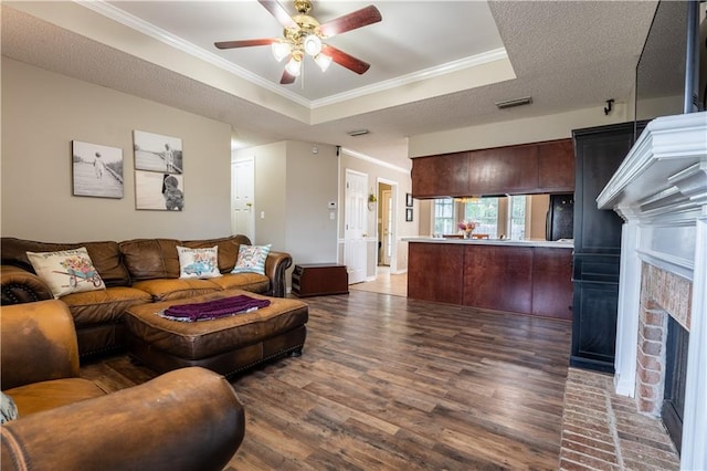 13330 Wages Ct, Mobile, AL 36695 - living area with ceiling fan, a raised ceiling, wood finished floors, ornamental molding, and a fireplace