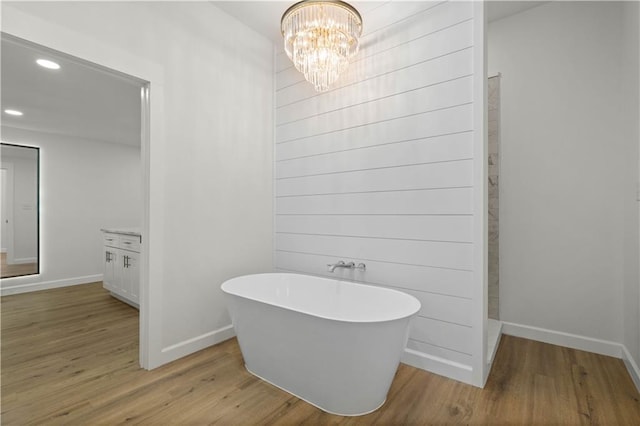 5305 Laurendine Rd, Theodore, AL 36582 - bathroom with wood finished floors, a soaking tub, a chandelier, and recessed lighting