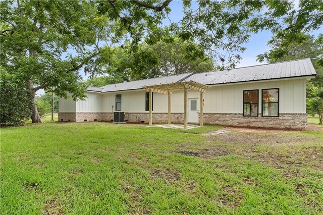 5305 Laurendine Rd, Theodore, AL 36582 - back of house featuring a pergola, a lawn, brick siding, board and batten siding, and crawl space
