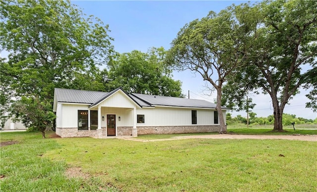 5305 Laurendine Rd, Theodore, AL 36582 - view of front of property with a front lawn and a metal roof