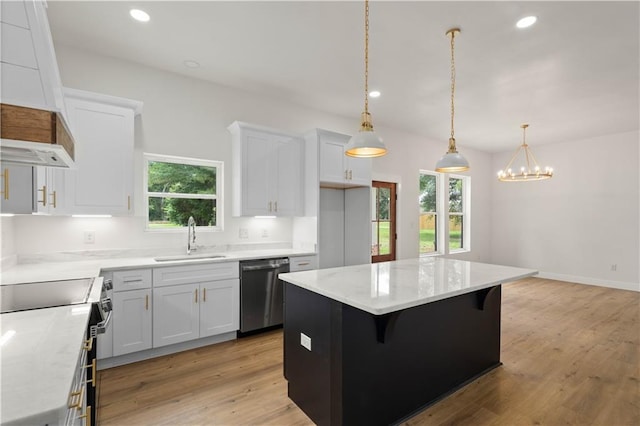 5305 Laurendine Rd, Theodore, AL 36582 - kitchen with stainless steel dishwasher, range, light wood-type flooring, a kitchen island, and white cabinetry