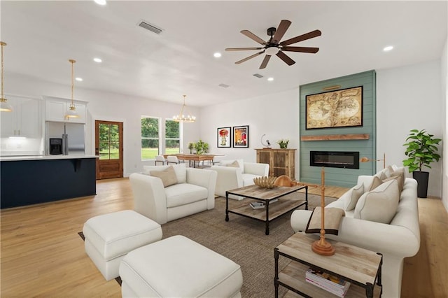 5305 Laurendine Rd, Theodore, AL 36582 - living area with light wood-style floors, recessed lighting, a large fireplace, ceiling fan, and a chandelier