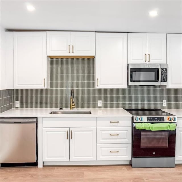 7498 Pinehill Rd, Daphne, AL 36526 - kitchen featuring stainless steel appliances, light countertops, and white cabinetry