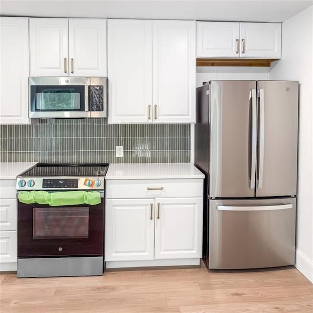 7498 Pinehill Rd, Daphne, AL 36526 - kitchen featuring stainless steel appliances, light countertops, white cabinets, and light wood-type flooring