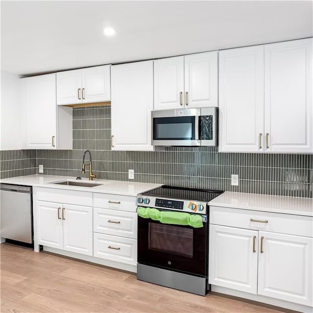 7498 Pinehill Rd, Daphne, AL 36526 - kitchen with appliances with stainless steel finishes, light countertops, and white cabinets