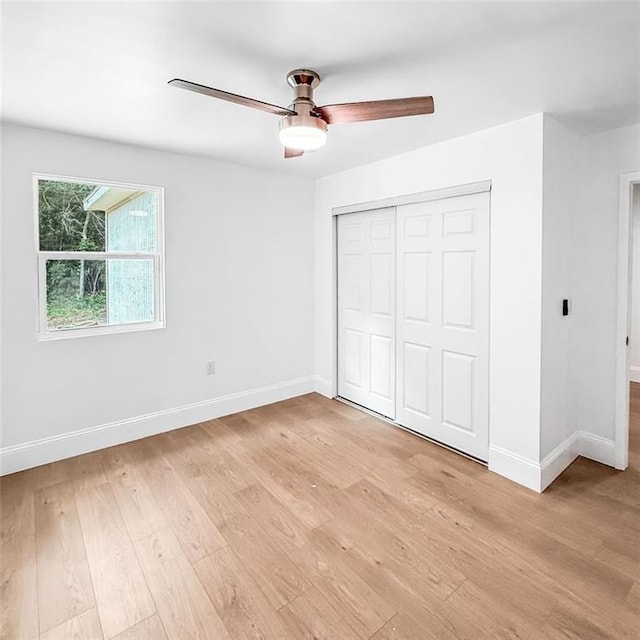 7498 Pinehill Rd, Daphne, AL 36526 - unfurnished bedroom with a closet, light wood-type flooring, and ceiling fan