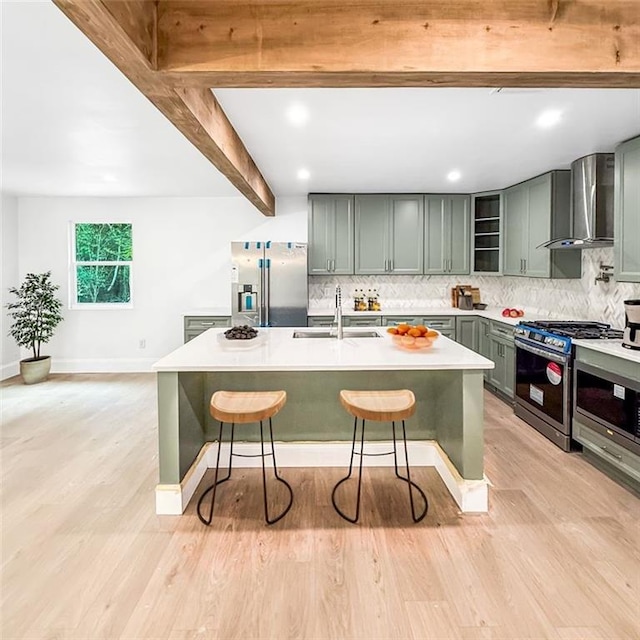 7498 Pinehill Rd, Daphne, AL 36526 - kitchen with stainless steel appliances, wall chimney range hood, decorative backsplash, a breakfast bar area, and light countertops