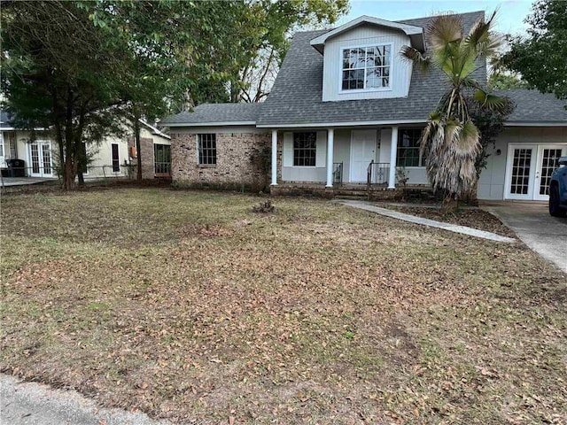 view of front of home featuring french doors and a front lawn