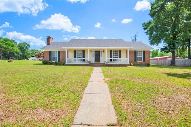 10437 Traci Dr, Semmes, AL 36575 - view of front of house featuring a porch, a chimney, a front yard, and brick siding