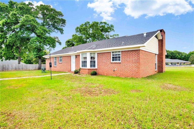 10437 Traci Dr, Semmes, AL 36575 - view of front of home featuring brick siding, fence, a front yard, and a chimney