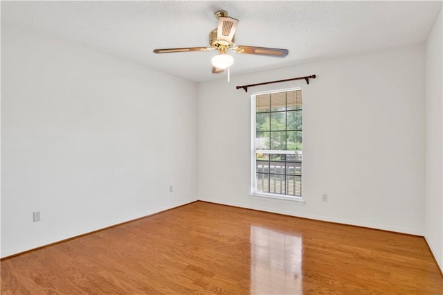 10437 Traci Dr, Semmes, AL 36575 - unfurnished room with baseboards, a ceiling fan, and wood finished floors