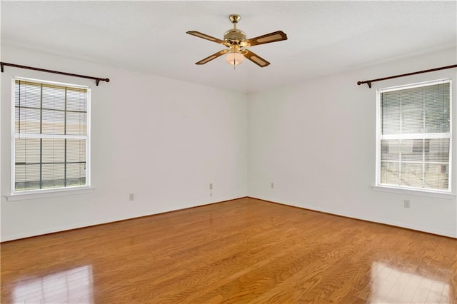 10437 Traci Dr, Semmes, AL 36575 - spare room with baseboards, a ceiling fan, and wood finished floors