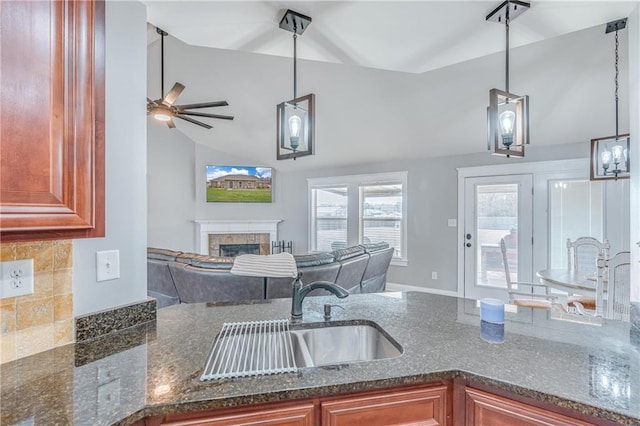 kitchen featuring lofted ceiling, sink, and hanging light fixtures