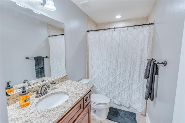 bathroom with vanity, curtained shower, and toilet