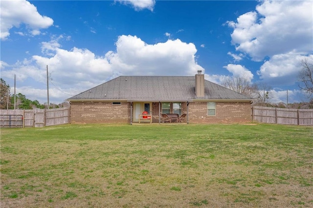 back of house with a yard and a patio