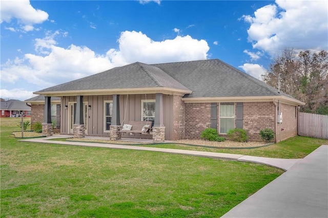 view of front of home with covered porch and a front lawn