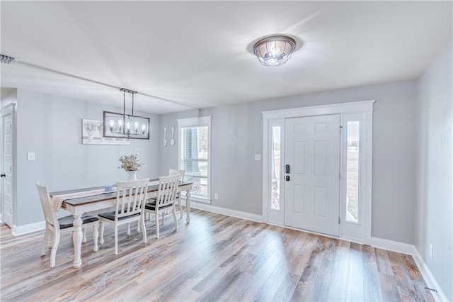 entryway featuring a chandelier and light wood-type flooring