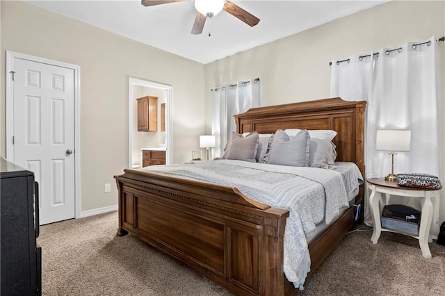 carpeted bedroom featuring ensuite bath and ceiling fan