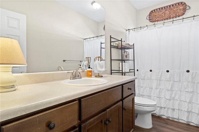 bathroom featuring hardwood / wood-style flooring, vanity, toilet, and a shower with curtain