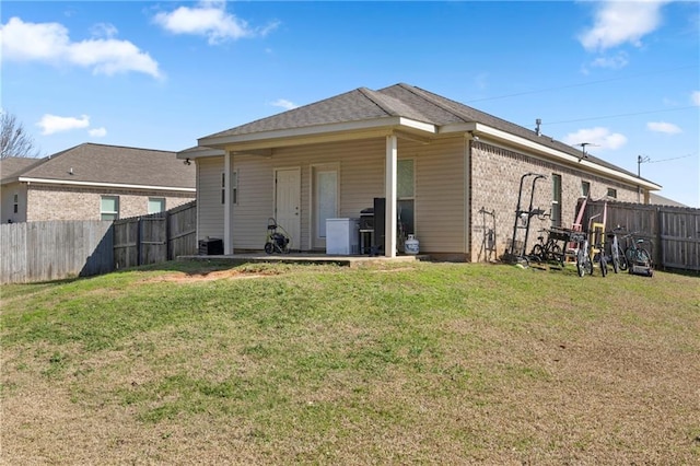 rear view of house featuring a lawn