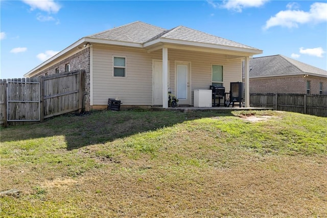 rear view of house featuring a patio and a lawn