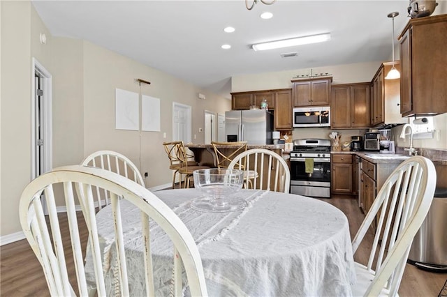 dining room with dark hardwood / wood-style floors and sink