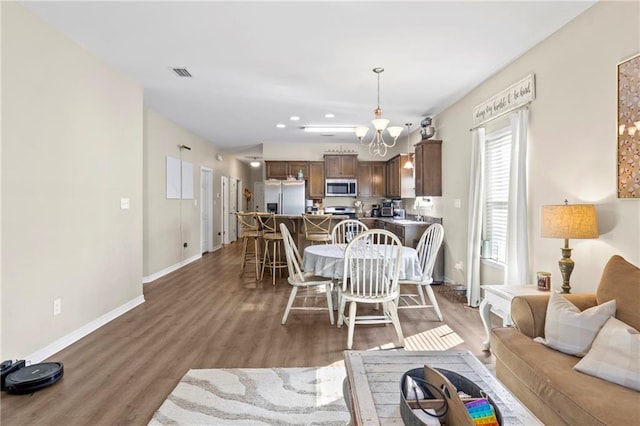 dining room featuring dark hardwood / wood-style floors and a chandelier