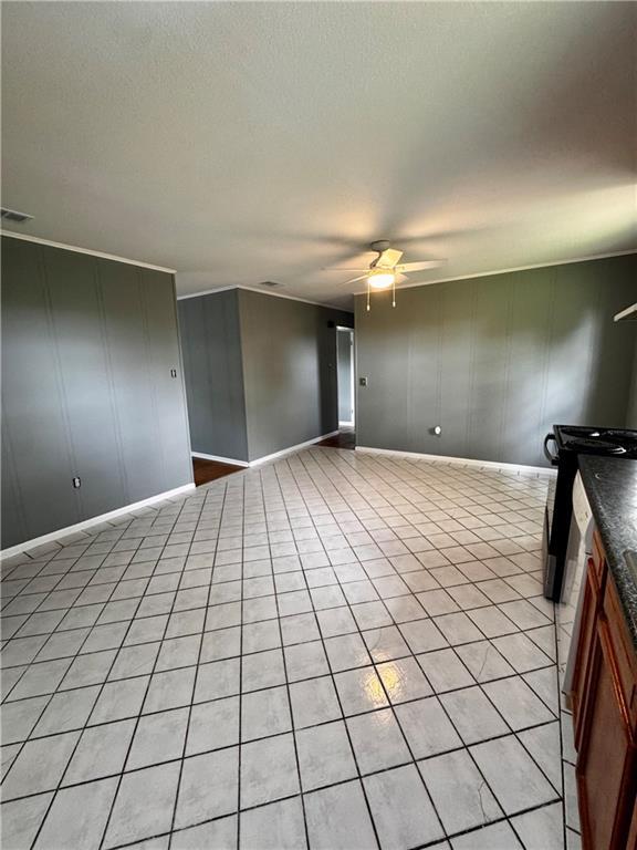 17080A Wayne Johnson Ln, Fairhope, AL 36532 - unfurnished living room with ceiling fan, baseboards, and light tile patterned floors