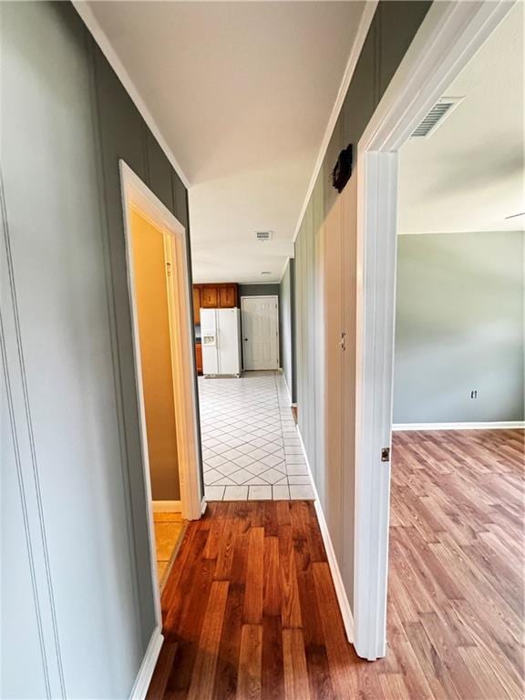 17080A Wayne Johnson Ln, Fairhope, AL 36532 - hall featuring light wood finished floors, crown molding, and baseboards