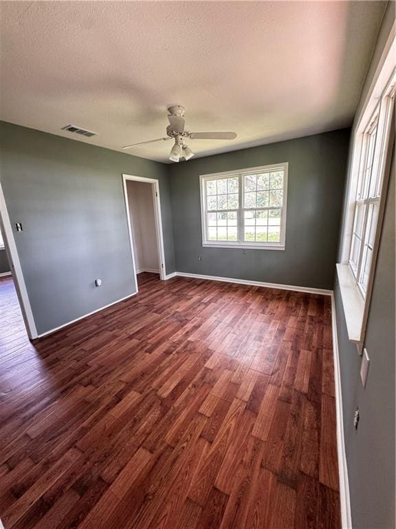 17080A Wayne Johnson Ln, Fairhope, AL 36532 - spare room with dark wood-style flooring, baseboards, a ceiling fan, and a textured ceiling