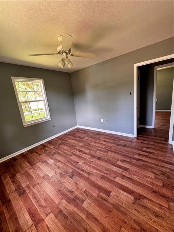 17080A Wayne Johnson Ln, Fairhope, AL 36532 - empty room featuring dark wood finished floors, a textured ceiling, baseboards, and ceiling fan