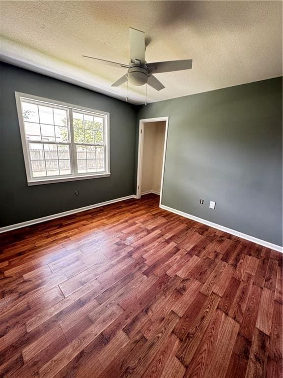 17080A Wayne Johnson Ln, Fairhope, AL 36532 - empty room with wood finished floors, a ceiling fan, baseboards, and a textured ceiling