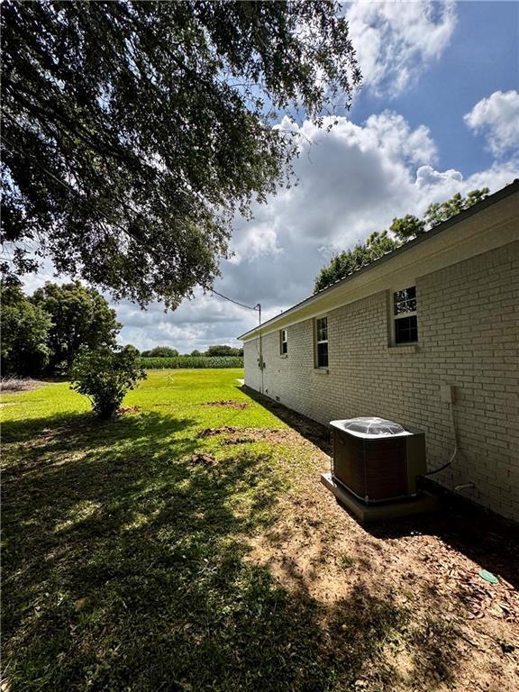 17080A Wayne Johnson Ln, Fairhope, AL 36532 - view of green lawn with central AC unit