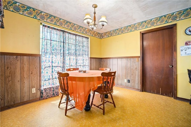 8170 Wilmer Georgetown Rd, Wilmer, AL 36587 - dining area with wooden walls, wainscoting, baseboards, and an inviting chandelier