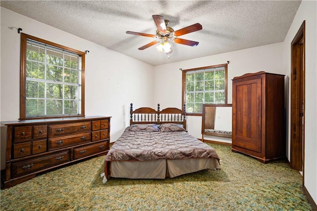 8170 Wilmer Georgetown Rd, Wilmer, AL 36587 - carpeted bedroom featuring a ceiling fan and a textured ceiling