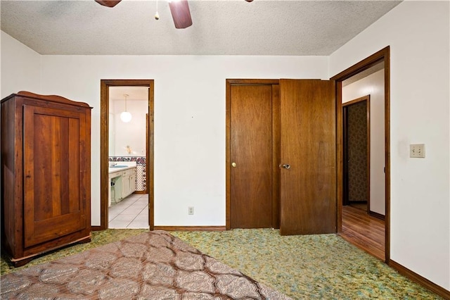 8170 Wilmer Georgetown Rd, Wilmer, AL 36587 - bedroom with a closet, baseboards, carpet flooring, a textured ceiling, and connected bathroom