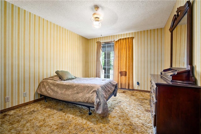 8170 Wilmer Georgetown Rd, Wilmer, AL 36587 - bedroom with a textured ceiling, wallpapered walls, light colored carpet, and baseboards