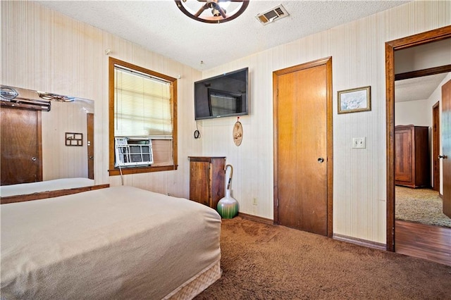 8170 Wilmer Georgetown Rd, Wilmer, AL 36587 - carpeted bedroom featuring baseboards, wallpapered walls, cooling unit, a textured ceiling, and visible vents