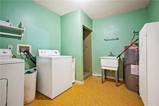8170 Wilmer Georgetown Rd, Wilmer, AL 36587 - laundry area featuring electric water heater, separate washer and dryer, laundry area, and a textured ceiling
